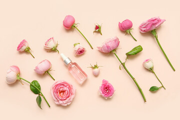 Bottle of cosmetic oil with rose extract and flowers on beige background