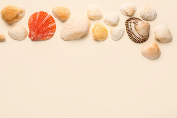 Beautiful seashells on beige background