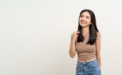 Beautiful smiling happy young asian woman in brown shirt. Charming female lady standing pose thinking on isolated white blank background. Asian cute people looking copy space for text advertise