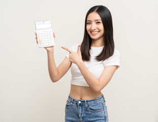 Beautiful smiling happy young asian woman holding calculator. Charming female lady standing pose financial concept.