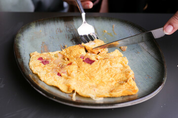 eating Plain Egg Omelette on table 