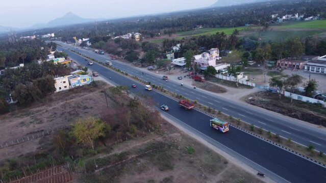 Dynamic FPV aerial view of Mumbai Pune Bangalore Highway at Sunset near Davangere in Karnataka, India