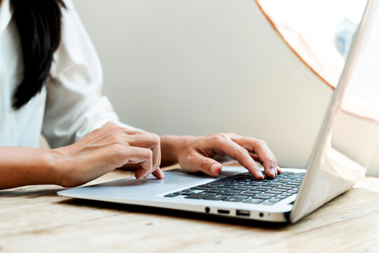 Asian Woman Working On Laptop At Home. Close Up Of Businesswoman's Hands Using Computer In Office. Technology And Lifestyle, Work From Home Concept. Closeup, Copy Space