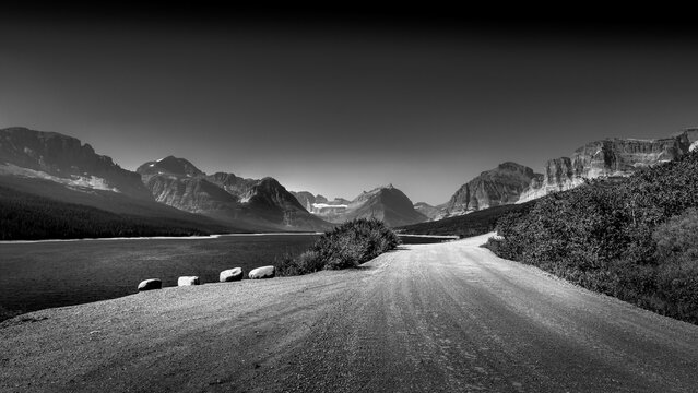 Black and White Photo of the gravel road along Lake Sherburne in the Many Glaciers area of Glacier National Park, Montana, USA