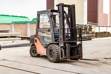 Fototapeta na wymiar Forklift in a modern automatic warehouse or factory. Moving heavy loads in the enterprise. Warehousing, machines concept. Warehouse logistics. Modern loader