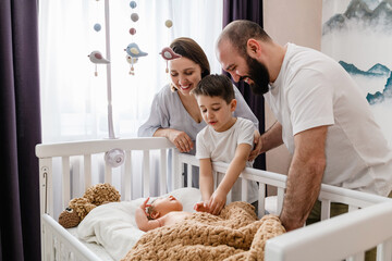 Happy family of four with newborn baby