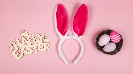 greeting card with bunny ears on pink background. happy easter.