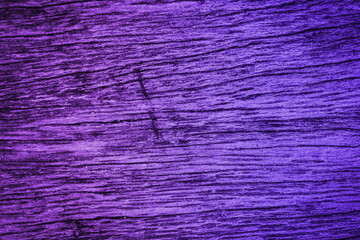 Cracked background with various scratch marks, wood texture with lilac and purple tones. Old wood background with strong and slightly dark tones.