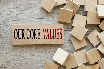 Our core values symbol. text on a wooden block. next to wooden cubes