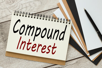 compound interest text on notepad desktop view from above