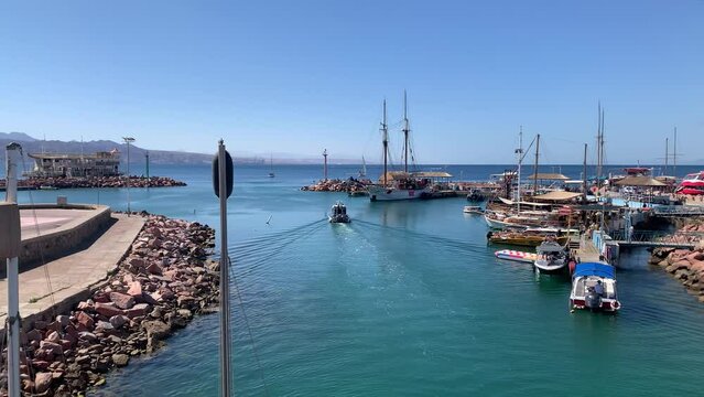 Police Boat Leave Eilat Marina Harbor on a Sunny Day, Israel - Wide