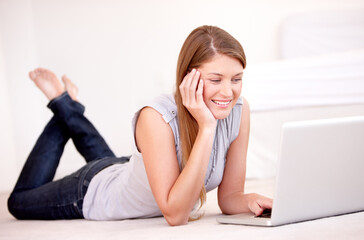 Obraz premium Relax, laptop and floor with woman in living room for social media, streaming and website. Search, technology and digital with female user typing at home for connection, email and internet