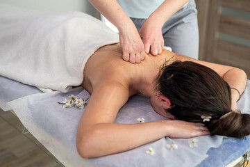 female masseur make relaxing massaging woman's back on spa