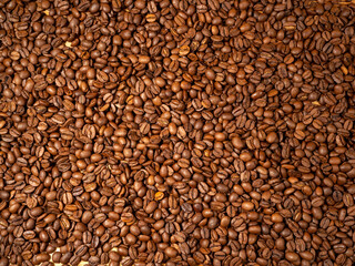 Background from roasted coffee beans. Scattered coffee beans.