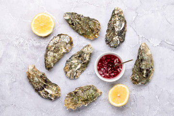 Fresh oysters with sauce and lemons
