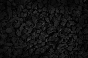 Fototapeta premium Black gray pebbles texture background, small stone gravel for garden decoration.