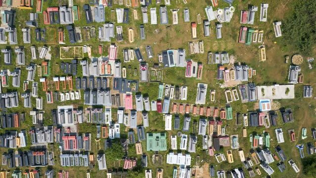 Overhead view over dysfunctional graveyard with randomly arranged graves