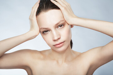Naklejka premium Glow, face portrait and a woman with beauty from skincare isolated on a white background in a studio. Serious, young and a female model for dermatology and cosmetics on a backdrop for care of skin