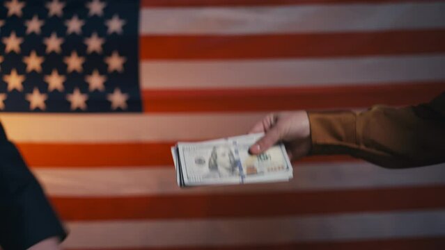 Male and female hands exchanging election badge for money, voter fraud in USA