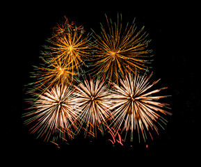 Multiple fireworks against the deep black sky. Bright  display of the fireworks