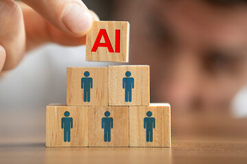 Close up shot of businessman putting the AI written wooden cube on top of others. Artificial Intelligence versus human concept