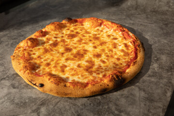 Four cheese pizza on stone table