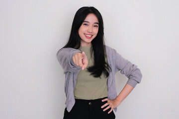 Asian young woman smiling while pointing finger to the camera