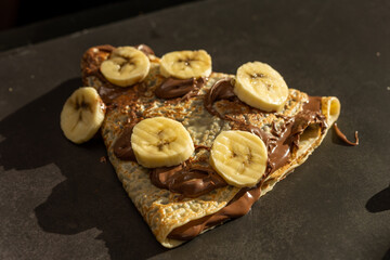 European pancake with chocolate cream and banana