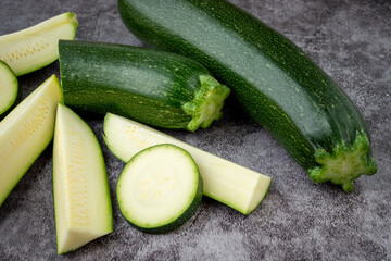 Fresh sliced zucchini on a black background