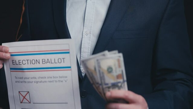 Man in business suit holding ballot paper and money, electoral fraud, corruption