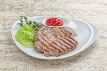 Grilled pork neck steak with ketchup