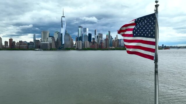 Aerial features two American USA flags with Lower Manhattan skyline cityscape. Patriotic America theme in urban city setting.