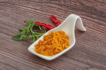 Yellow vibrant curcuma powder in the bowl