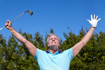 Winner, sports and old man with hands up in golf celebration on blue sky background with smile....