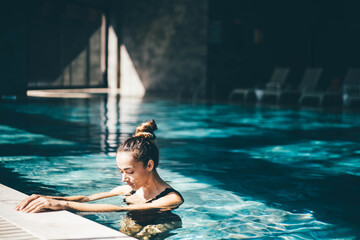 Woman relaxing in the swimming pool.