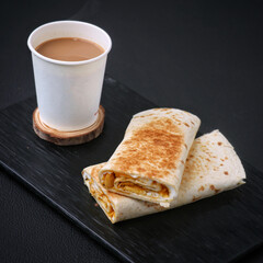 Tea cup full of tea and tasty shawarma