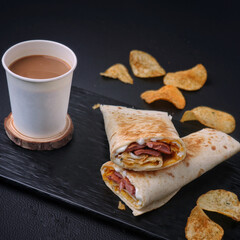 Tea cup full of tea and tasty shawarma