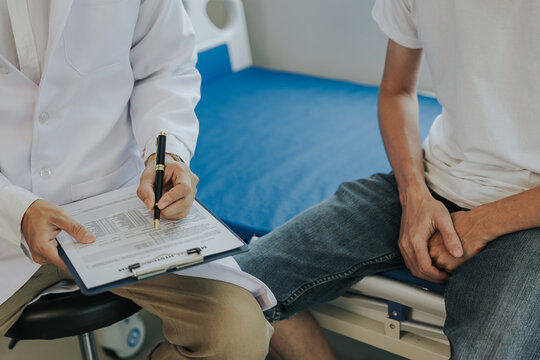 Male health concepts. The young man with pain consulted a doctor for treatment. The doctor is interviewing and advising the patients.