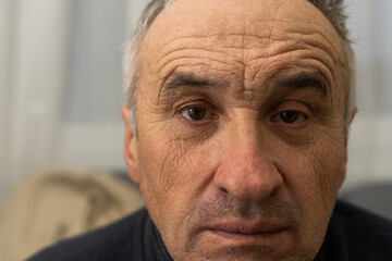 old man face part closeup eyes looks at camera
