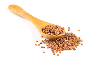Uncooked buckwheat on wooden spoon
