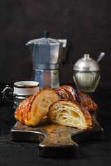 Classic breakfast with croissant cut on half and coffee
