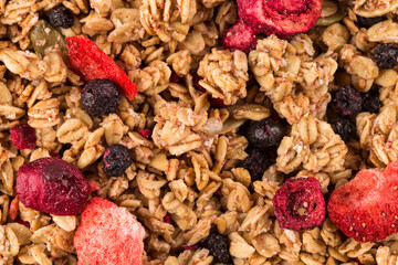 Muesli oat cereals close up background with dry fruits