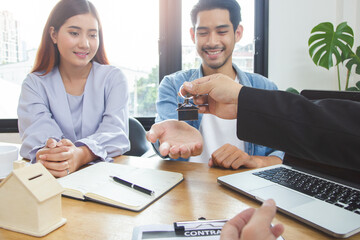 Landlord agent giving house property keys to new tenant after lease is confirmed