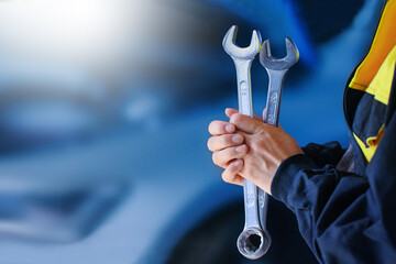 Auto Repair Shop. Auto mechanic working on car broken engine in mechanics service or garage. Transport maintenance wrench detial Wide banner or panorama photo.