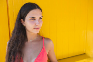 Woman in bikini with a yellow background