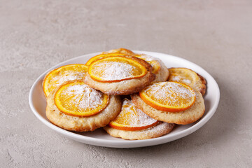 homemade cookies with orange on a round plate, copy space