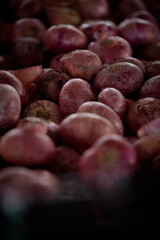 Pile of Organic red onions at vegetable market