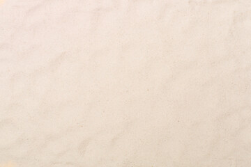 Fototapeta na wymiar Sand on beach as background, top view