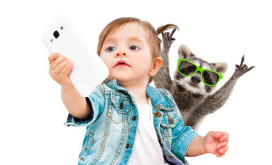 Cute little girl makes selfie with raccoon in sunglasses on phone isolated on white background