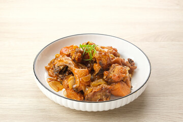Ayam Goreng Mentega or Butter Chicken in white plate. Indonesian food.
